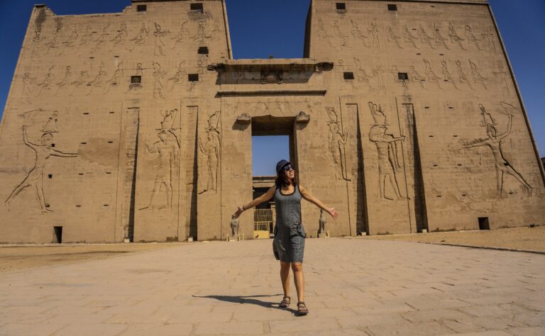 A young tourist at the entrance to the Edfu Temple near the Nile River in Aswan. Egypt, return of tourism in the coronavirus pandemic after 6 months stopped
