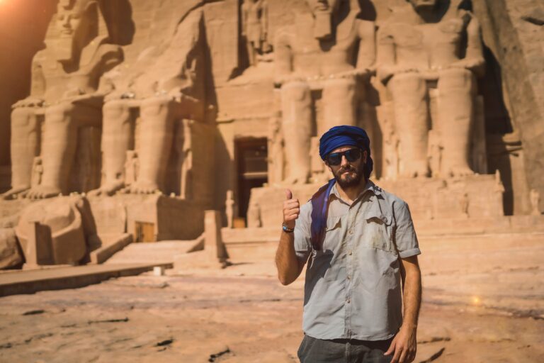 A young tourist with a blue turban visiting the Abu Simbel Temple in southern Egypt in Nubia next to Lake Nasser. Temple of Pharaoh Ramses II, travel lifestyle